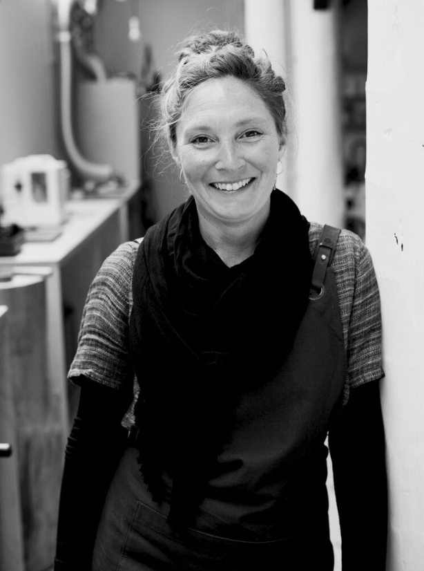 A jeweller in a workshop in black and white